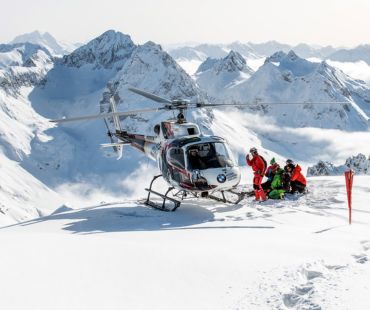 Helicopter and skiers landed in backcountry Helicopter and skiers landed in backcountry