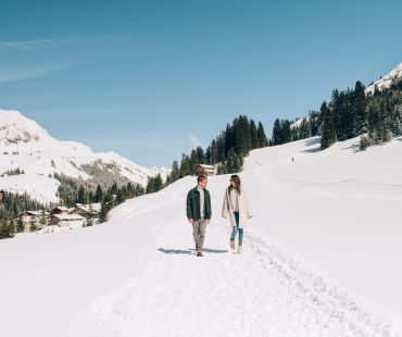 People walking through snowy trails People walking through snowy trails