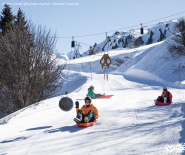 People sledding down trails at Meribel People sledding down trails at Meribel