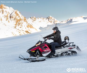 Person riding snowmobile on the trails Person riding snowmobile on the trails